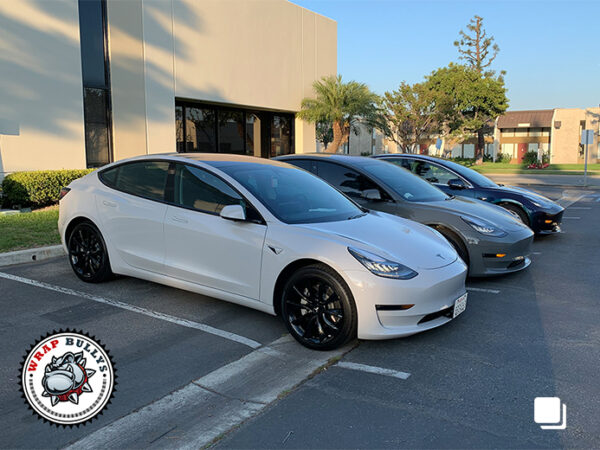 Trifecta of Style: Tesla Model 3 Trio Wrapped in 3M Gloss Storm Gray, Avery Gloss Dark Gray, and 3M Gloss Rising Sun