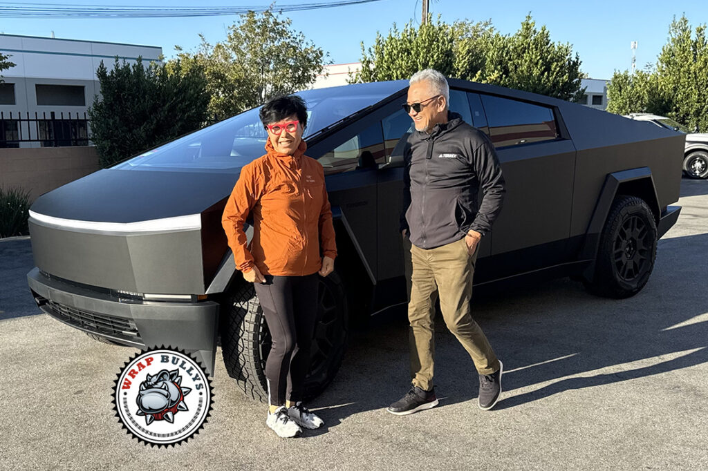 People standing beside a Tesla Cybertruck wrapped in 3M Deep Matte Black