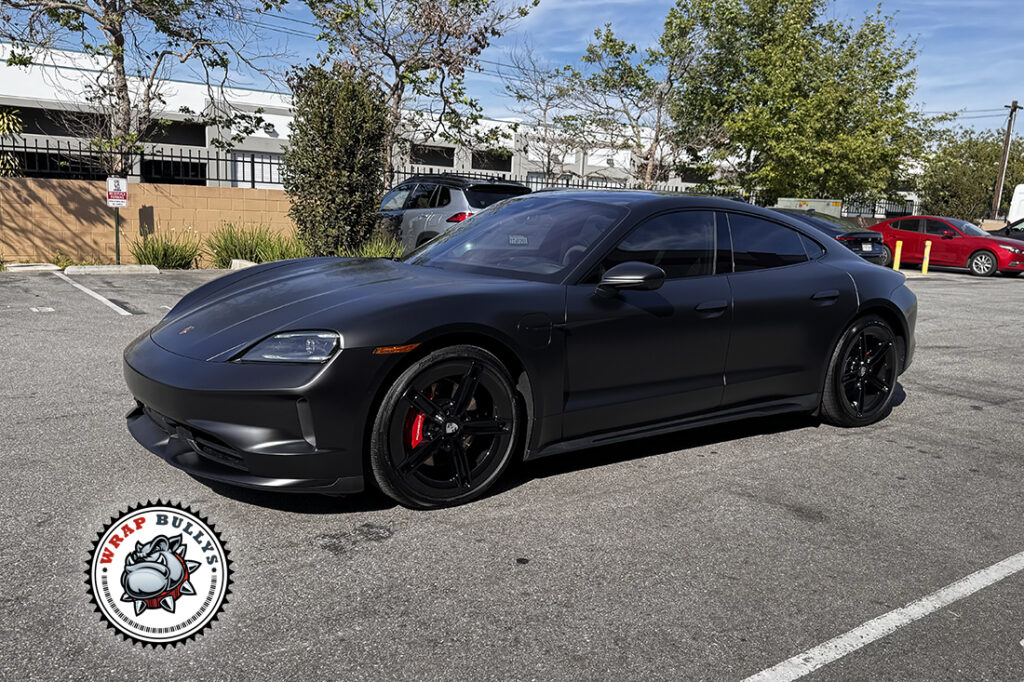 Porsche Taycan finished in Satin Black Color PPF, front passenger-side three-quarter view