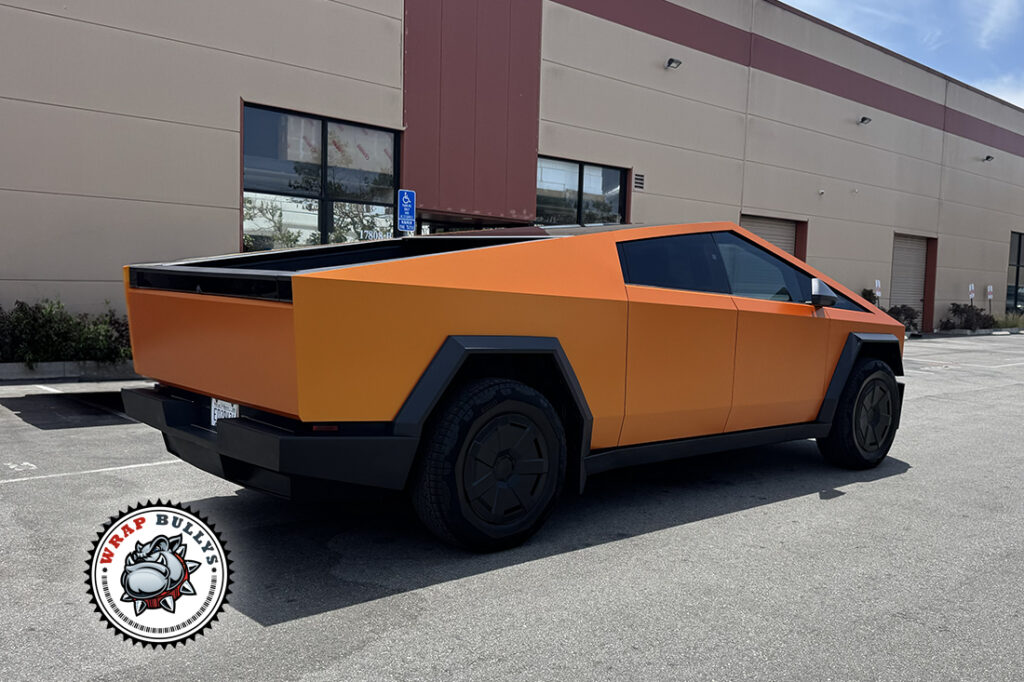 Tesla Cybertruck finished in Orange Gold Color PPF, rear three-quarter view