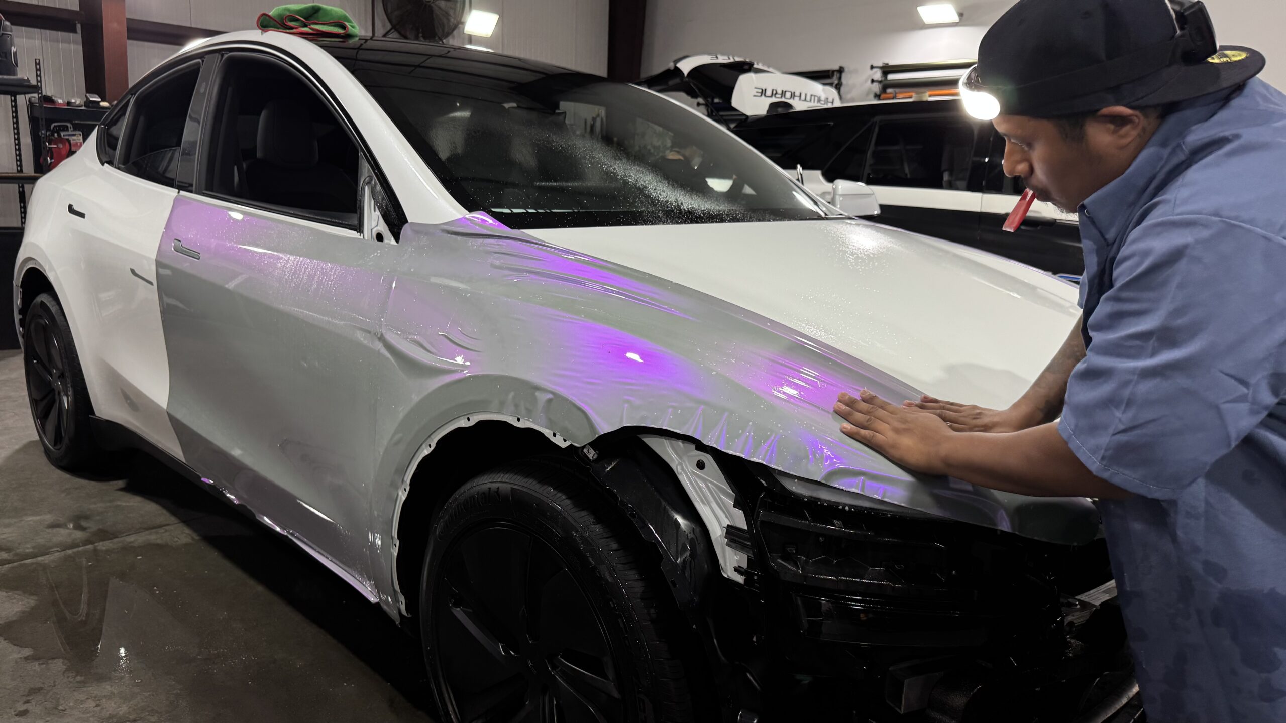 Wrap Bullys technician focused on hands-on vehicle wrap installation work